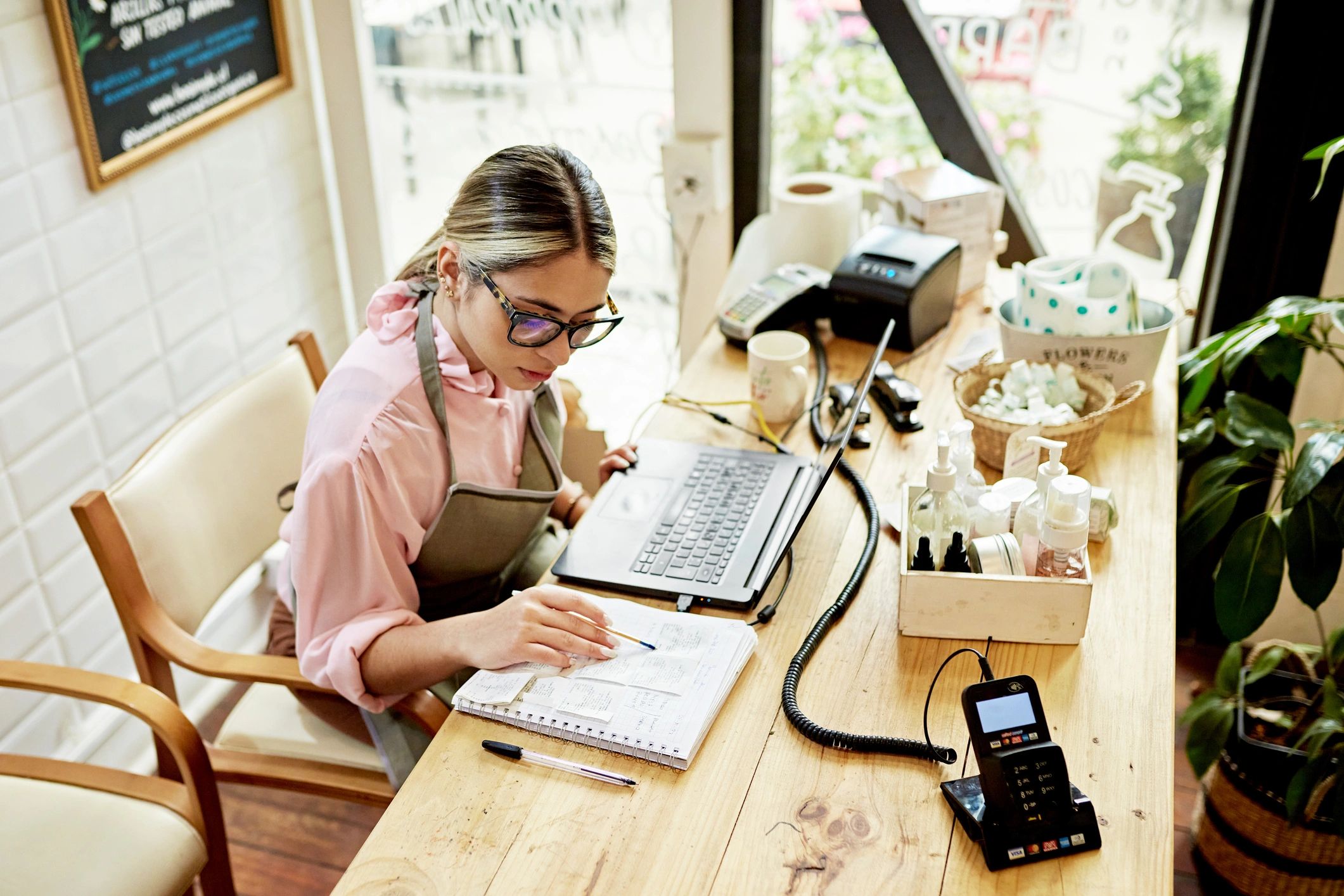 Small business owner working on a laptop in a retail shop